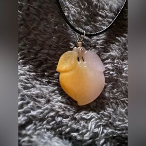 Peach hand-carved gemstone pendant, likely made from natural agate or chalcedony